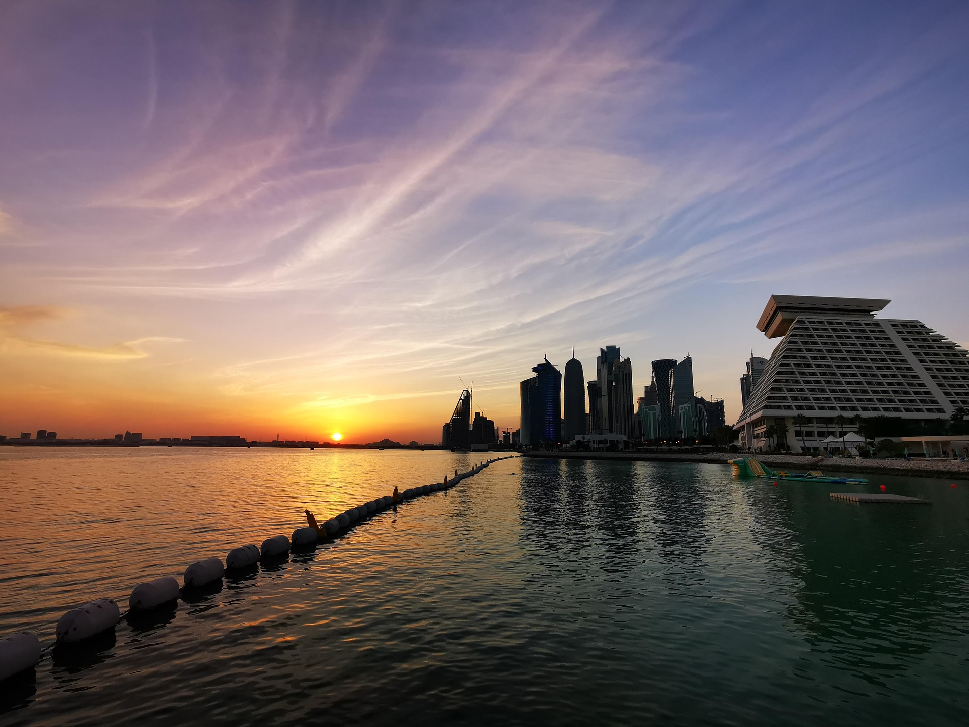 Sunset over the Doha bay with the West Bay skyline in the distance